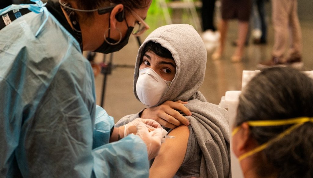A student looks back at his mother as he is vaccinated at a COVID-19 vaccination clinic for students 12 and older in May 2021 in San Pedro, Calif. (AP Photo/Damian Dovarganes, File)