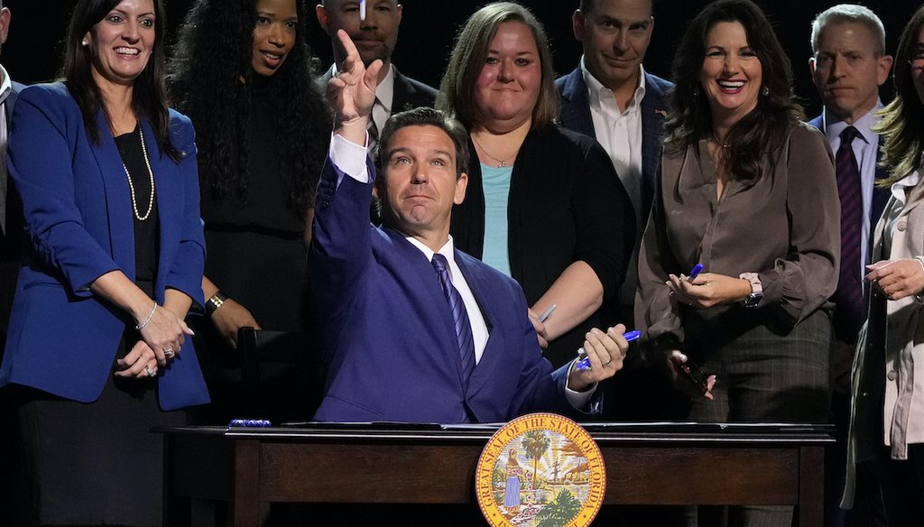 Florida Gov. Ron DeSantis throws markers into the audience after signing various bills during a bill signing ceremony at the Coastal Community Church at Lighthouse Point, Tuesday, May 16, 2023, in Lighthouse Point, Fla. (AP)