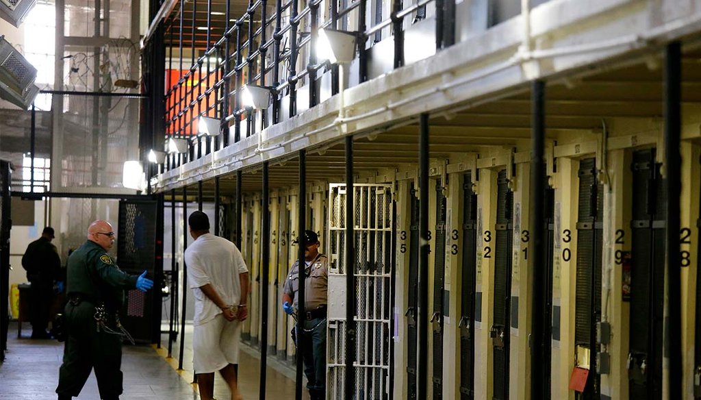 An inmate is led out of his block cell Aug. 16, 2016, at San Quentin State Prison, in San Quentin, Calif. (AP)