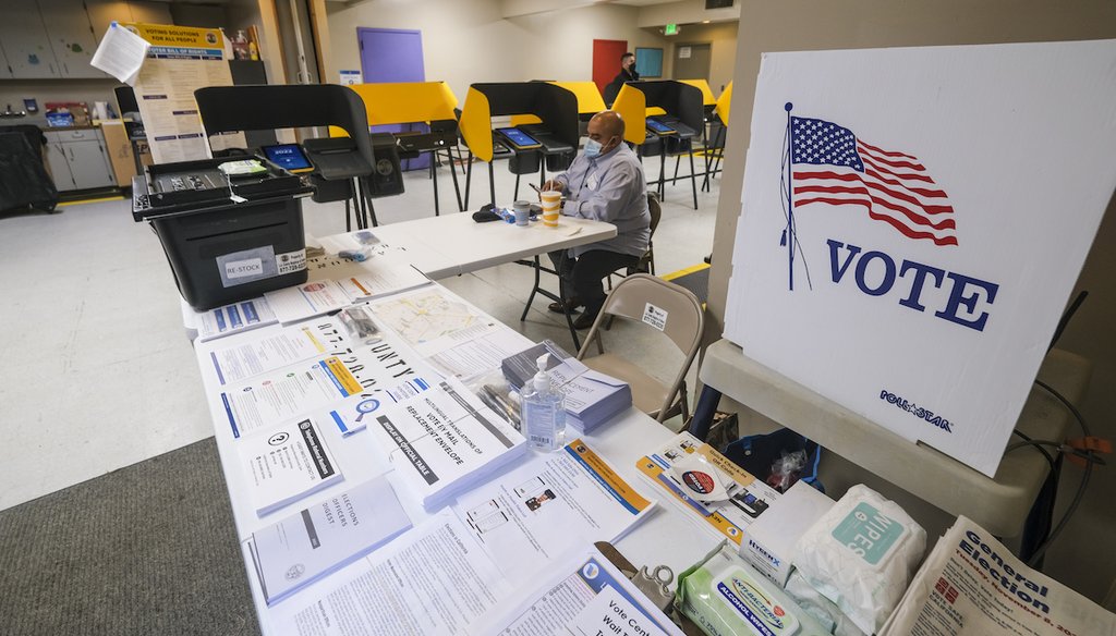 An election staff waits for voters at a voting station Nov. 8, 2022, in Pacoima, Calif. All the state's active registered voters are sent a mail ballot, but can choose to vote in person instead. (AP Photo/Ringo H.W. Chiu)